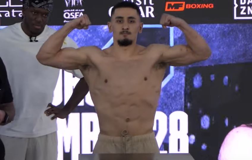 AnEsonGib flexing muscles at weigh in in Qatar