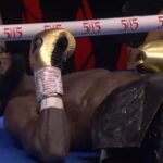 Deontay Wilder lying down on the canvas after KO by Zhilei Zhang