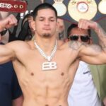 Edgar Berlanga flexing muscles at weigh in for Canelo fight