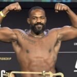 Jon Jones flexes muscles at UFC 309 weigh in